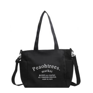 Black canvas tote bag with side pockets and adjustable shoulder strap for women