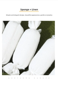 Close-up of white linen and sponge jewelry pillows for watch and bracelet display
