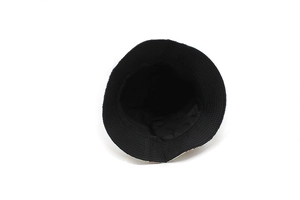 Detailed interior view of a black bucket hat with vibrant botanical floral prints on the brim