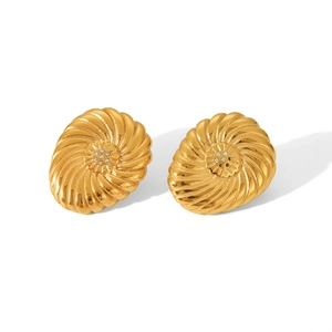 Golden vintage screw pattern earrings with sparkling center stones on white background