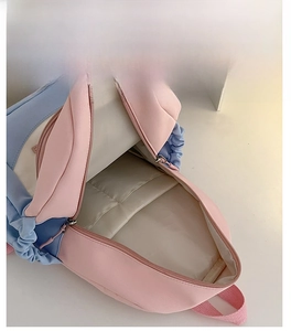 Top view of the pink and blue backpack interior showing spacious internal capacity