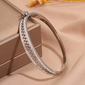 Macro detail of silver titanium steel zipper bracelet with sparkling diamond inlay