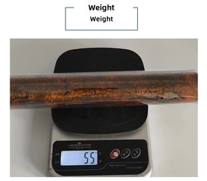Close-up showing the 55g weight measurement of a spider web tulle roll on a scale