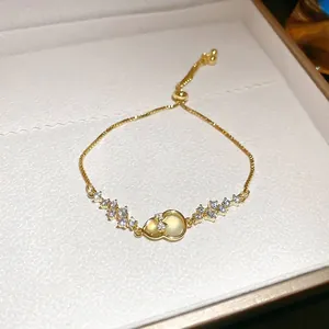 Adjustable gold plated gourd bracelet featuring yellow cat eye stone and sparkling zircons