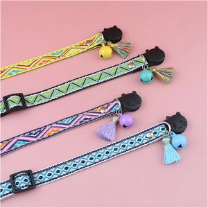 Colorful plaid cat collars with bells and tassels in four different vibrant patterns