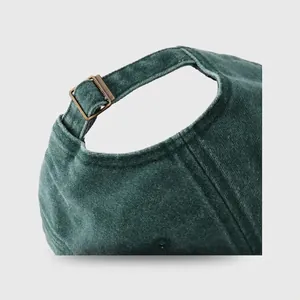 Green corduroy baseball cap back view with vintage bronze metal buckle adjustment