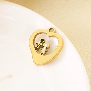 Close-up of golden stainless steel heart pendant with boy and girl silhouettes on ceramic