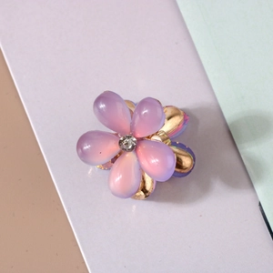 Close-up of purple gradient resin flower hair clip with a sparkling crystal center