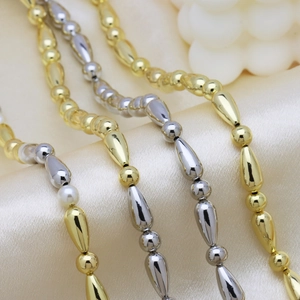 Polished 18k gold and silver plated bamboo beaded pearl necklace set on silk fabric