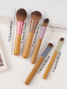 Detailed view of 5 mini makeup brushes with floral metal ferrules and wood handles