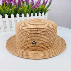 Flat top straw boater hat with black 'M' metal emblem and wide brim for sun protection