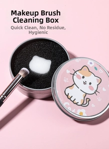 Detail of dry makeup brush cleaner tin with a white cat-shaped charcoal sponge center
