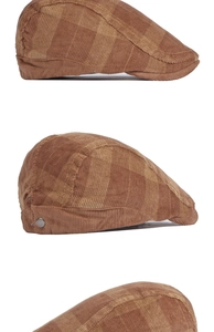 Detailed view of the corduroy texture and brown plaid pattern on a vintage ivy cap