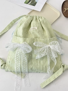 Stylish pastel green drawstring backpack featuring delicate white lace bow accents