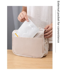 Detail of beige hanging toiletry bag with external pocket for easy item access