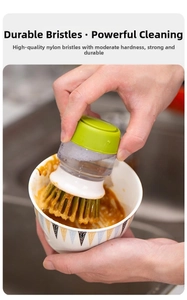 Close-up of kitchen cleaning brush with ergonomic handle removing dirt from a bowl