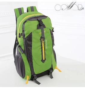 Detail view of green and grey hiking backpack with trekking pole attachments and side zippers