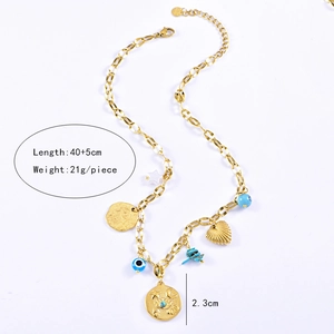 Detailed view of titanium gold necklace with coin, heart pendants and devil eye beads