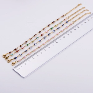 Detailed view of adjustable evil eye gold bracelets with multicolored beads and lobster clasp