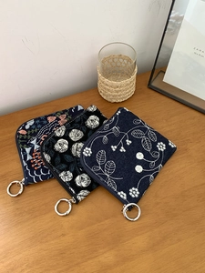 Three square cotton linen pouches with floral embroidery and metal ring zippers