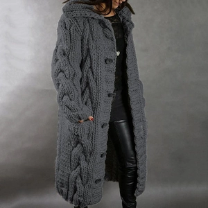 Detail showing grey cable knit texture with large buttons and pockets on a long cardigan