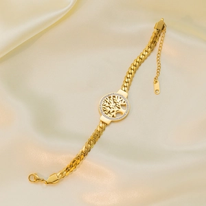 Gold stainless steel Tree of Life bracelet featuring sparkling crystals on satin backdrop