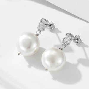 Macro shot of S925 hallmark on pearl earrings with shiny zircons and silver finish