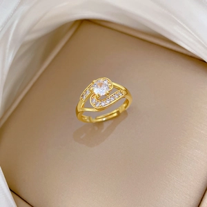 Close-up of gold-plated ring with large circular zircon and sparkling pave crystals
