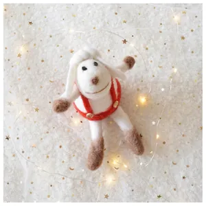 Detail of handmade wool felt sheep ornament with red overalls and wooden buttons