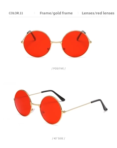 Close-up of retro round gold metal sunglasses featuring vibrant red lenses and nose pads