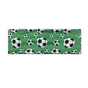 Elastic green sports headband featuring classic black and white football soccer prints