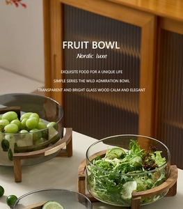 Close-up of a Nordic glass fruit bowl with a premium solid wood base for home decor