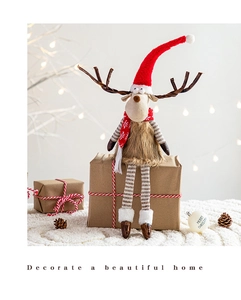 Detail of Christmas reindeer plush with striped long legs and festive red knitted accessories