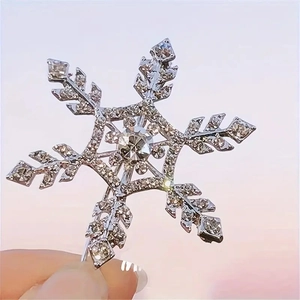 Sparkling silver snowflake hair clip with white rhinestones and central crystal stone