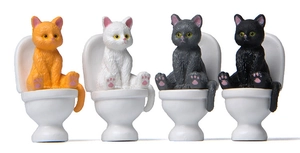 Set of four colorful miniature cats sitting on toilets for creative garden landscaping