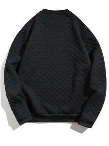 Detail of men's black crewneck sweatshirt with textured checkerboard embossing