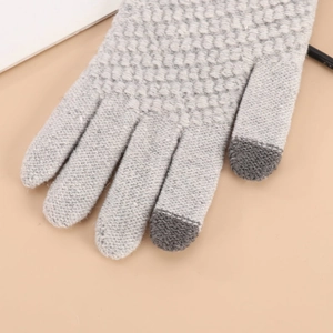 Close-up of light grey knit winter gloves with dark grey touchscreen sensitive fingertips