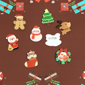 Set of acrylic Christmas brooches featuring Santa, gingerbread man and reindeer designs