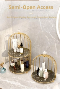 Macro view of gold birdcage tiered shelves with black marble base for perfumes