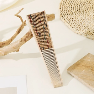 Detail of vintage Portuguese cork folding fan with floral and butterfly patterns