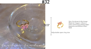 Detail of adjustable gold ring with heart-shaped pink zircon and copper plating