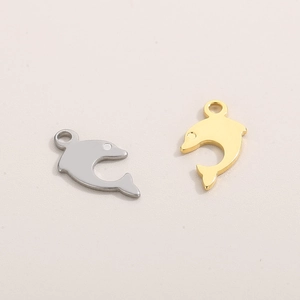 Polished gold and silver dolphin charms for DIY jewelry making on a beige background