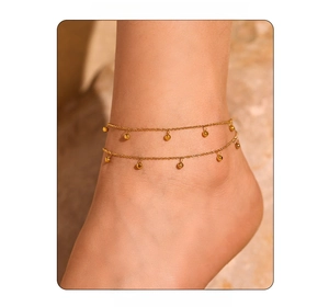 Close-up of double-layer gold beaded anklet showing layered drape on the ankle