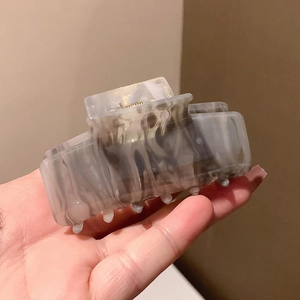 French ink marble acetate square hair claw clip for women shown in hand