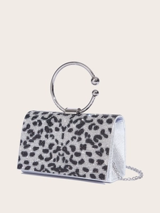 Detailed close-up of a silver leopard print evening clutch with sparkling rhinestones