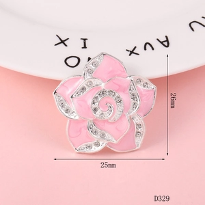 Pink enamel camellia flower charm with rhinestones and dimensions shown as 25mm by 26mm