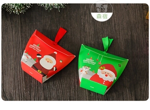 Close-up of festive Christmas gift boxes with Santa and reindeer on dark wood table
