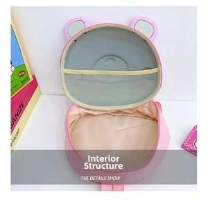 Interior view of pink animal backpack showing main compartment and yellow mesh pocket