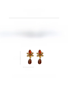 Macro detail of vintage floral earrings with amber resin drops and rhinestone inlay
