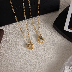 Elegant gold titanium steel necklace featuring interlocking heart and double ring pendants